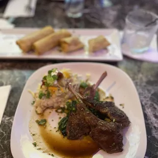 Jerk chicken egg rolls (back) Lamb chops, mashed potatoes, and spinach