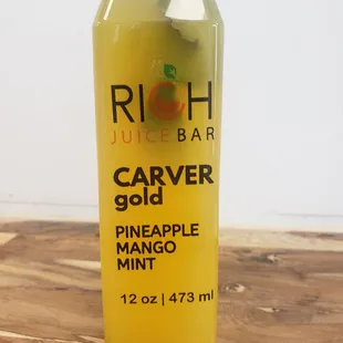 a bottle of juice on a wooden table