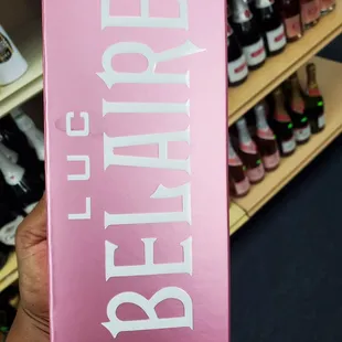 a person holding a pink box