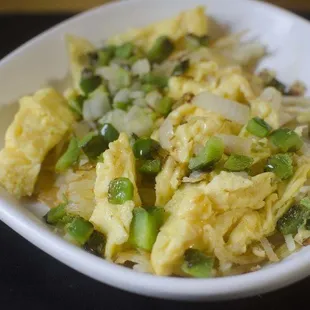 a bowl of scrambled eggs and green beans
