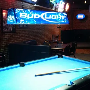 a pool table and neon signs