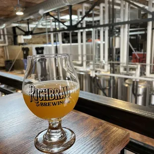 a glass of beer on a bar