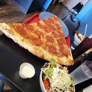 Actual large slice was enough for two. We did not need those side salad but we always make an attempt to eat our greens.