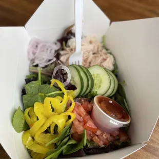a salad in a paper container