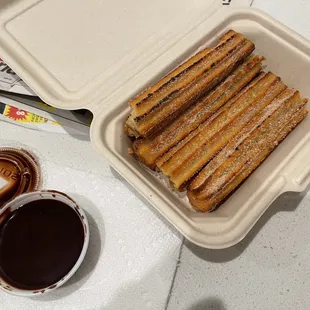 Caramel filled churros with chocolate sauce.