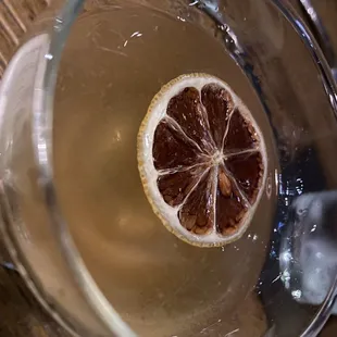 a half of a grapefruit in a glass