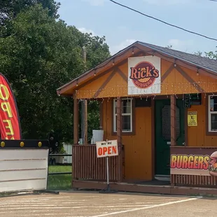 a small restaurant with a sign for burgers