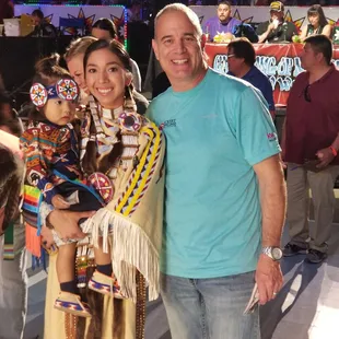 Mark Rickert and a special family at the Gathering of Nations Pow Wow.  Rickert Property Group gave away $$$ to each tiny tot dancer