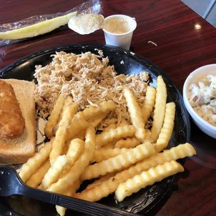 Pulled Chicken Plate, Fries, Baked Potato Salad, hash brown cake, a pickle, and white BBQ sauce.