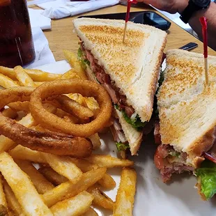 Ham &amp; bacon club sandwich, fries and battered onion rings.