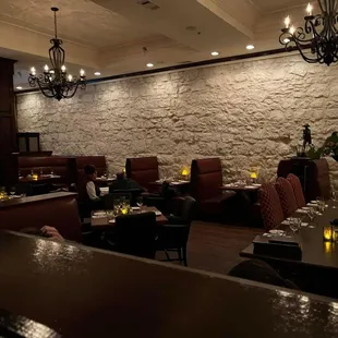 a restaurant with a stone wall