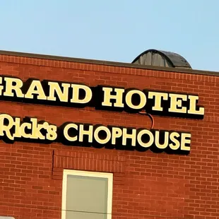 a brick building with a sign that reads grand hotel rick's chophouse