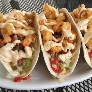three fish tacos on a plate