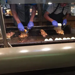 a man preparing food on a grill