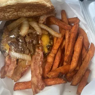 The burger had a great amount of bacon and grilled onions