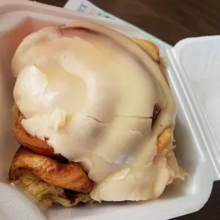 a close up of a pastry in a styrofoam container