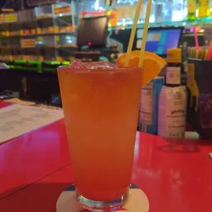 a bright orange drink on a red table