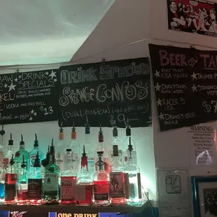 a variety of liquor bottles on a bar counter