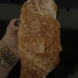  a hand holding a pastry