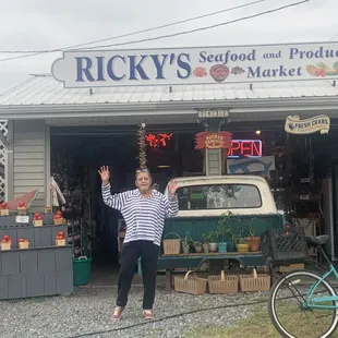 My mom in front of the stand waiting for her crabs