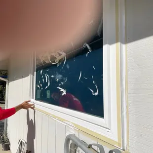 Trimming/smoothing caulk filled edges.