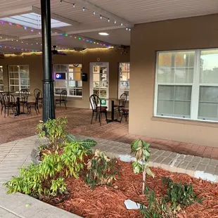 a patio with tables and chairs