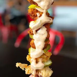 a hand holding a fried chicken sandwich