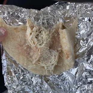 a hand holding a tortilla