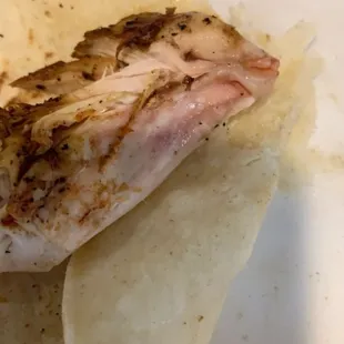 a piece of fish on a tortilla