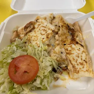 a chicken quesadilla in a styrofoam container