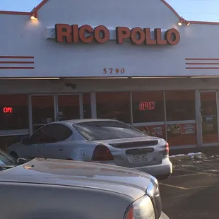 a row of parked cars in front of a restaurant