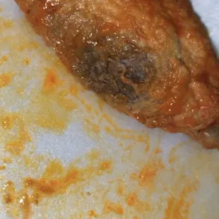 a half eaten chicken breast on a plate