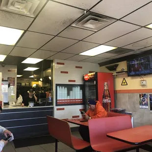 a man sitting at a table in a fast food restaurant