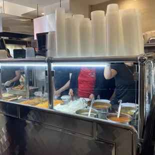 a group of people preparing food in a restaurant