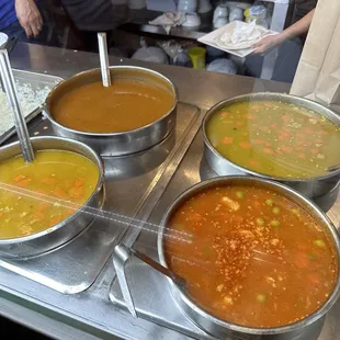 four bowls of soup in a kitchen