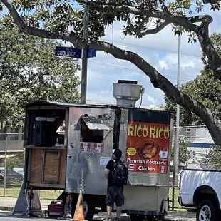 a man standing in front of a food truck