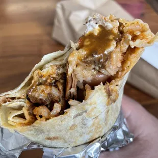 a hand holding a burrito