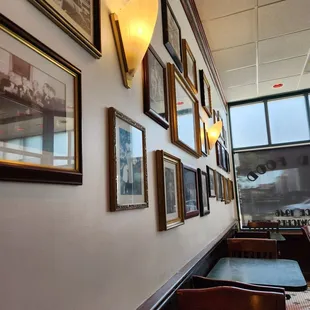 a row of framed photographs on the wall