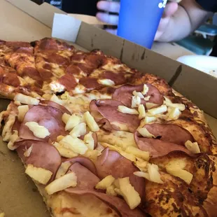 a pizza with ham and cheese