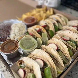 a tray of tacos and chips