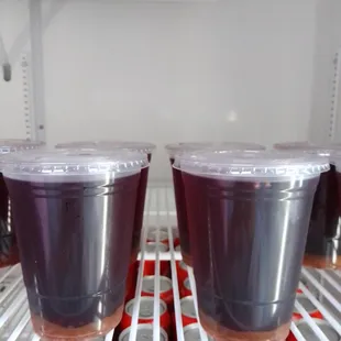 two cups of juice in a refrigerator