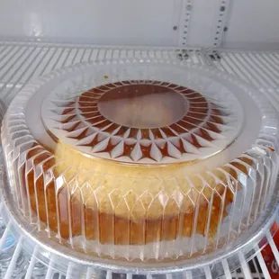 the inside of a refrigerator with a cake in it