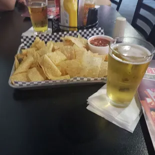 a tray of chips and a glass of beer