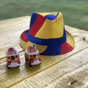 a hat and two toy cars