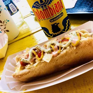 a hot dog on a paper plate