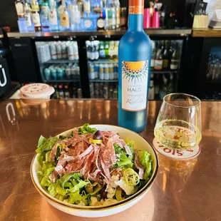 La Jolla salad is an upgraded Greek with charcuterie, here with a delicious crisp Reisling from Germany