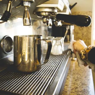 a person preparing a cup of coffee