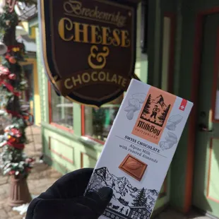  a hand holding a chocolate bar