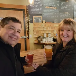 a man and a woman holding beer glasses