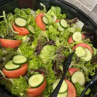 a salad with cucumbers and tomatoes